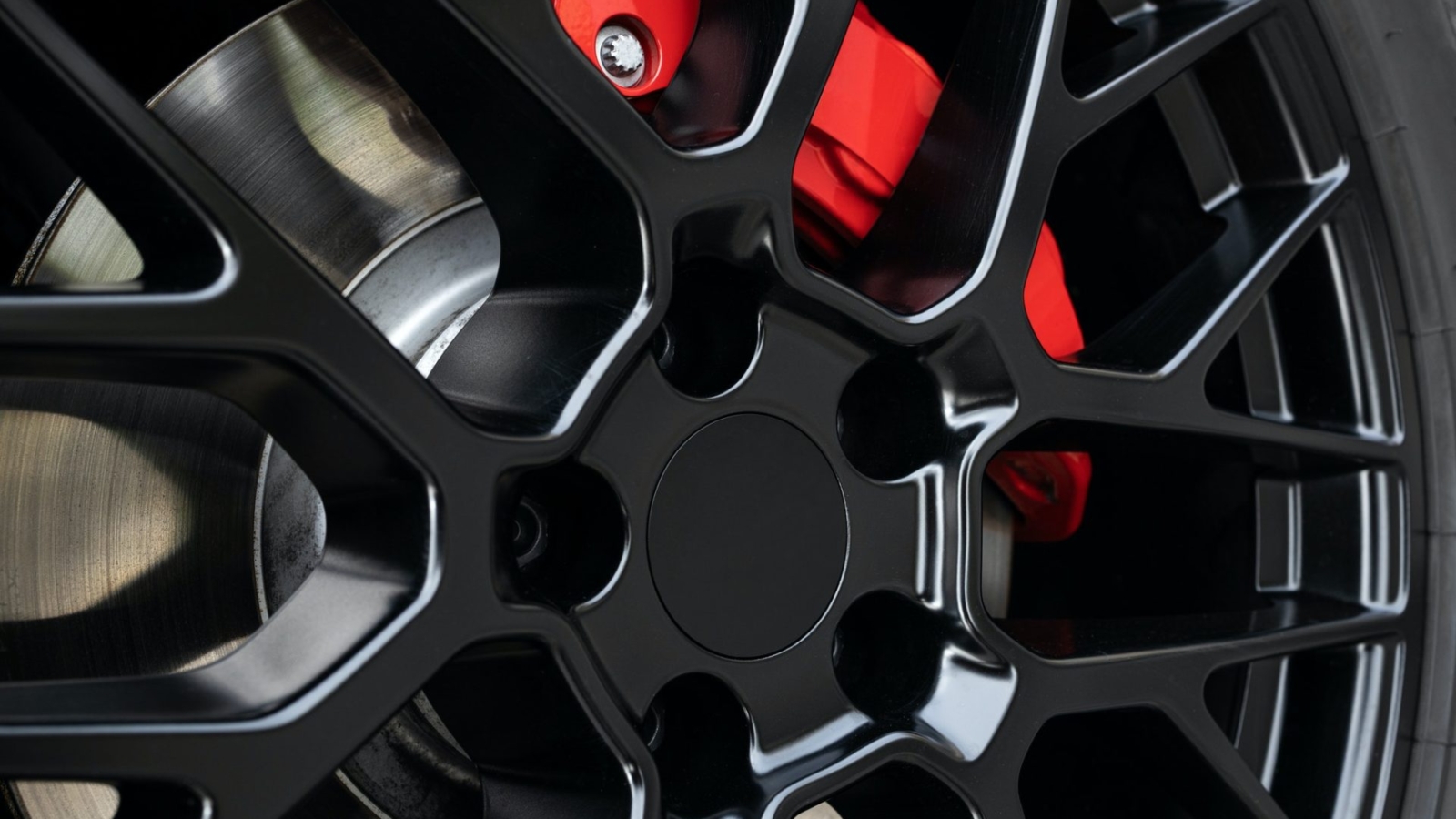 sport-rim-and-red-brake-caliper-of-car-e1651049772640.jpg